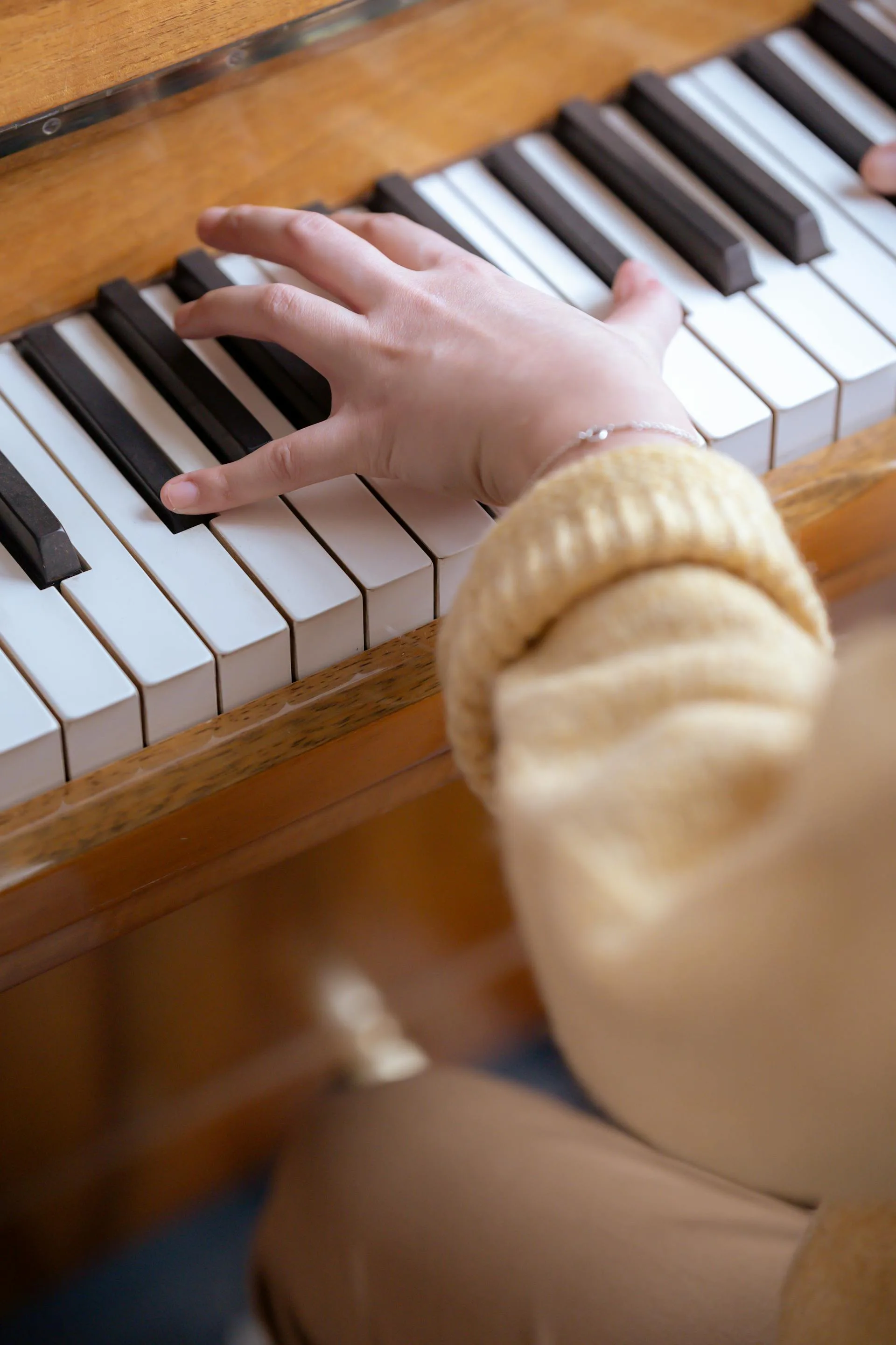 Woman playing piano during a music lesson